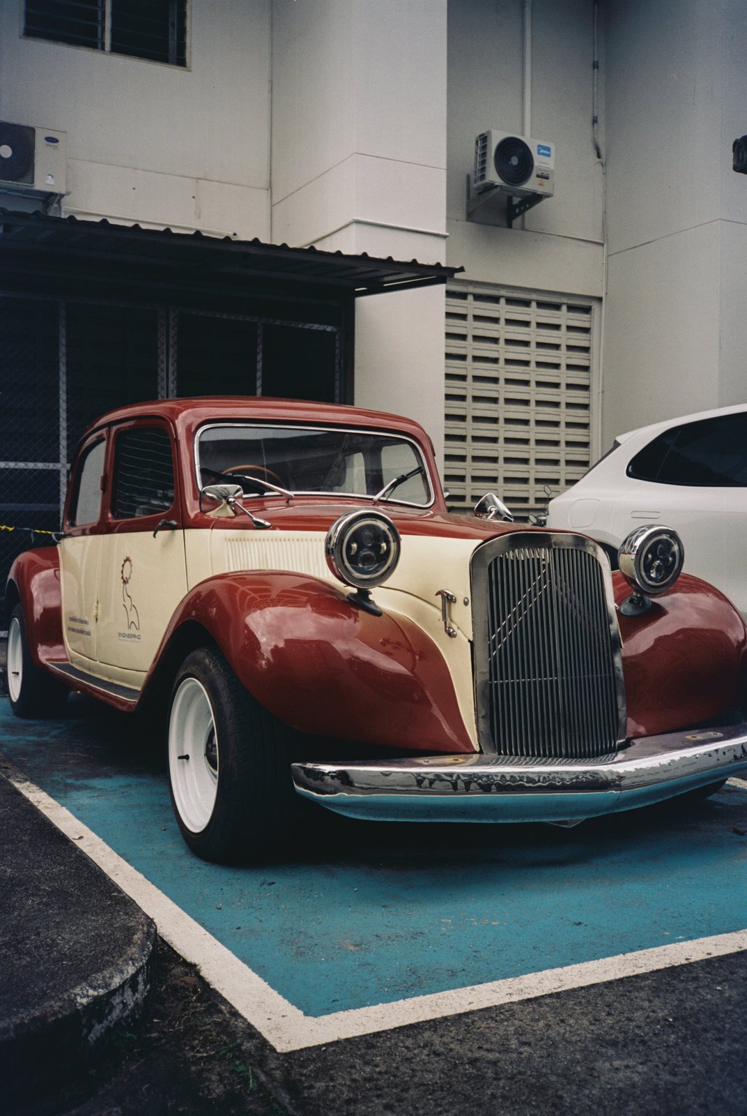 A vintage red and cream car